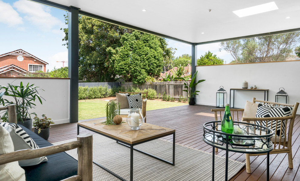 Photo of a mid-sized contemporary backyard patio in Sydney with decking and a roof extension.