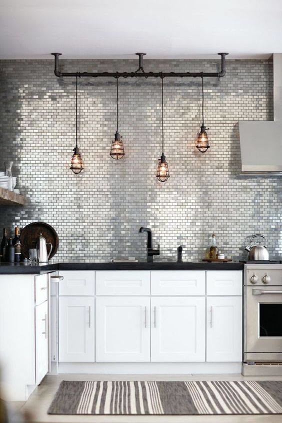 Large transitional l-shaped concrete floor and gray floor enclosed kitchen photo in Orange County with an undermount sink, shaker cabinets, white cabinets, solid surface countertops, gray backsplash, mosaic tile backsplash, stainless steel appliances and no island