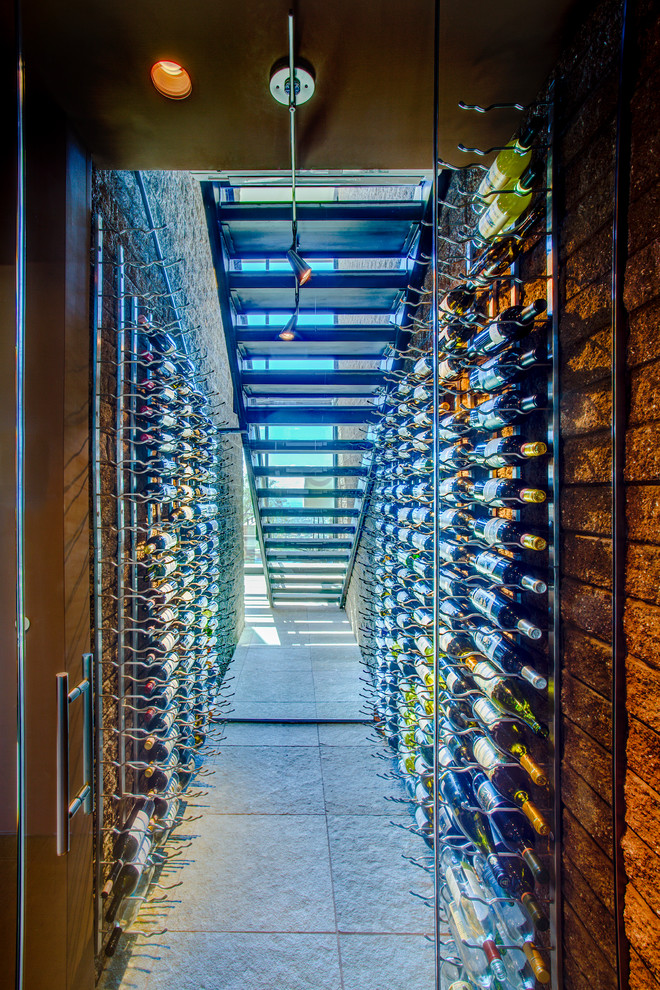 Inspiration for a small contemporary wine cellar in Phoenix with display racks, concrete floors and grey floor.