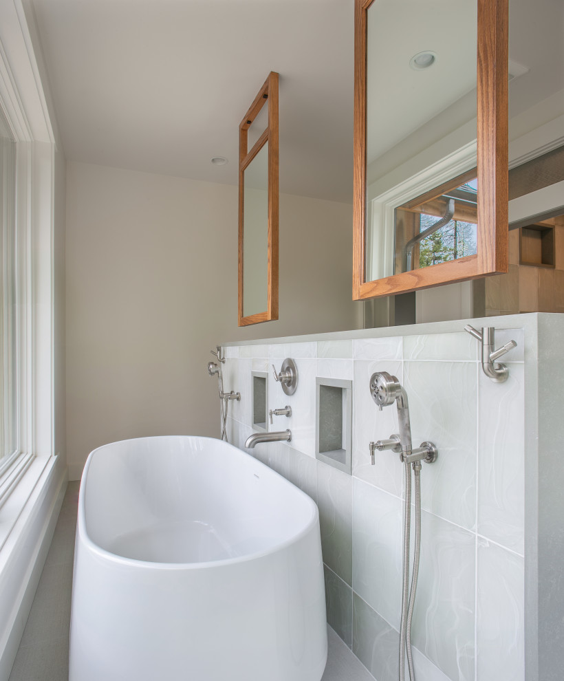This is an example of a mid-sized contemporary master bathroom in Seattle with shaker cabinets, white cabinets, a freestanding tub, an alcove shower, a wall-mount toilet, blue tile, porcelain tile, white walls, ceramic floors, an undermount sink, engineered quartz benchtops, white floor, a sliding shower screen, green benchtops, a shower seat, a double vanity and a built-in vanity.