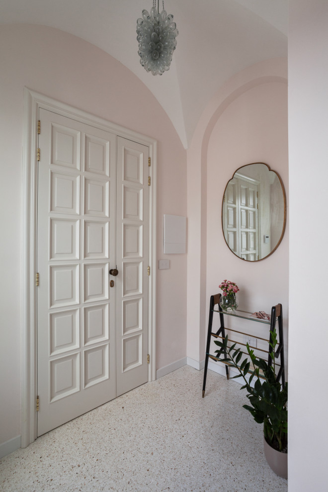 This is an example of a contemporary entryway in Other with pink walls, terrazzo floors, a double front door, a white front door, multi-coloured floor and vaulted.