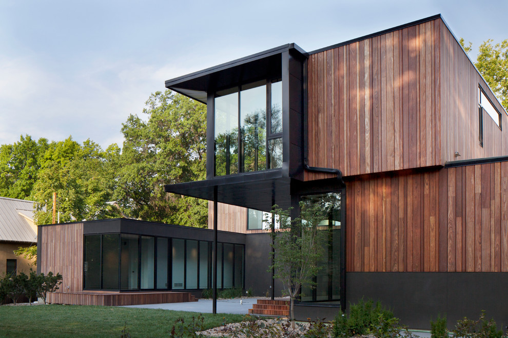 Modern two-storey exterior in Kansas City with wood siding and a flat roof.