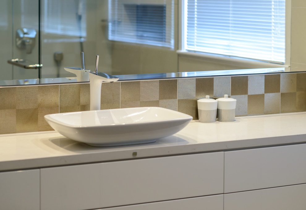 Inspiration for a small contemporary bathroom in Melbourne with a vessel sink, flat-panel cabinets, white cabinets, engineered quartz benchtops, an open shower, metal tile, porcelain floors, multi-coloured tile and beige walls.