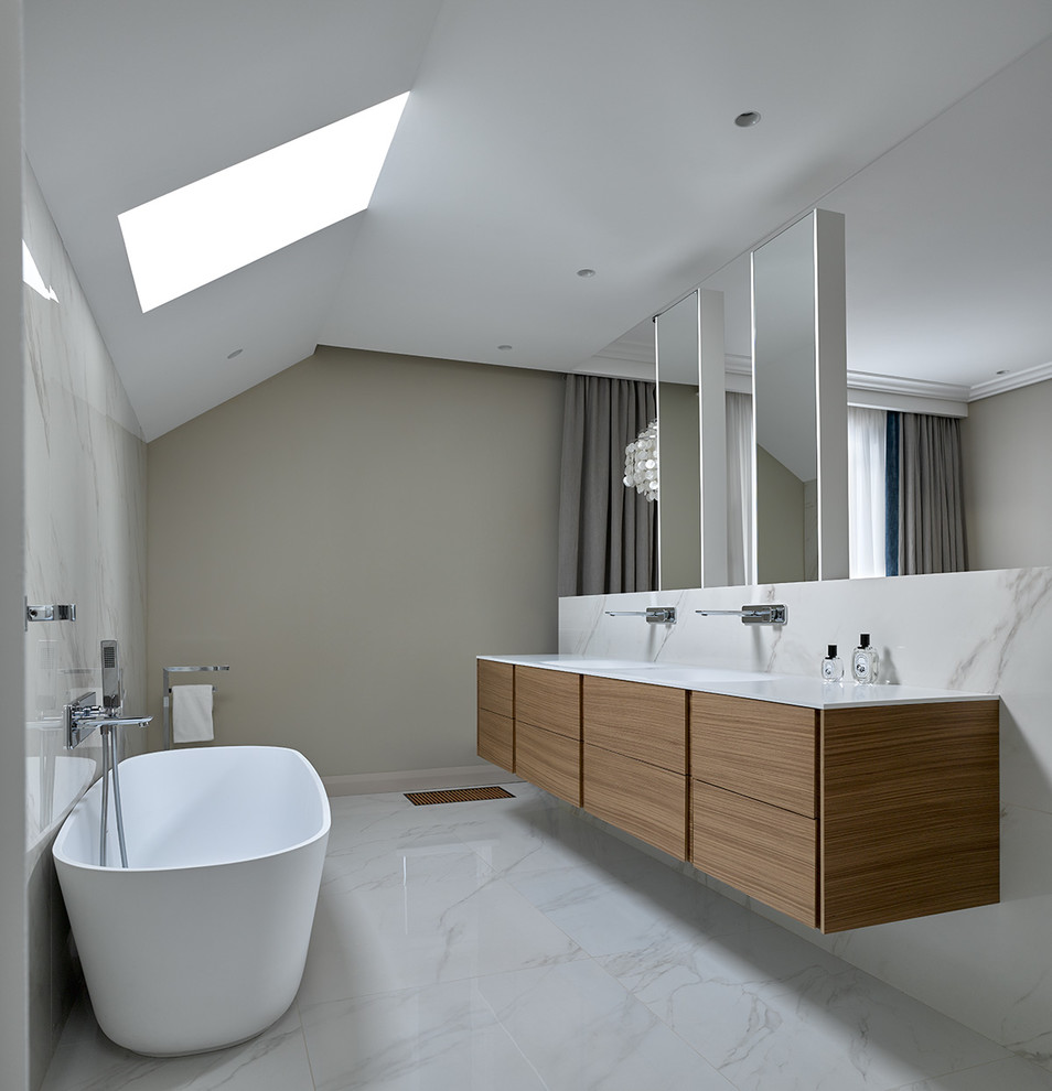 Design ideas for a contemporary master bathroom in Other with flat-panel cabinets, medium wood cabinets, a freestanding tub, white tile, grey walls, an integrated sink and white floor.
