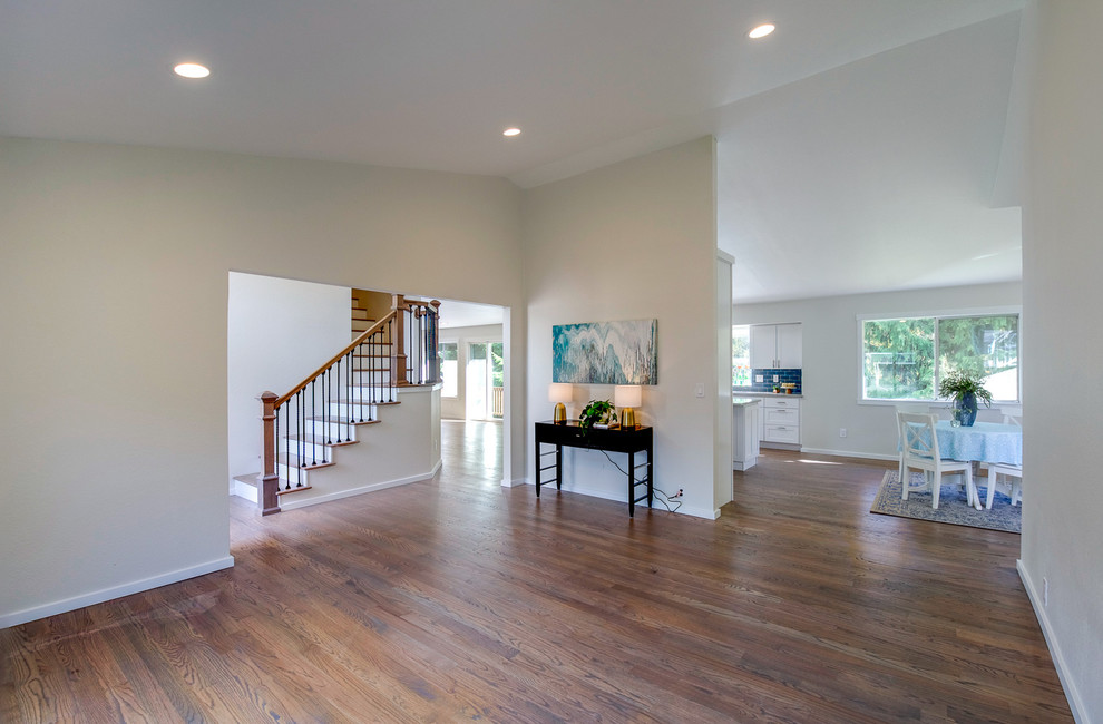 Mid-sized transitional medium tone wood floor and brown floor foyer photo in Seattle with white walls and a blue front door