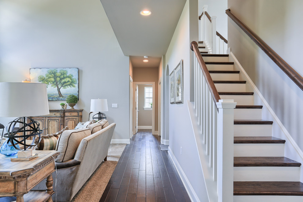 Hallway - mid-sized transitional dark wood floor hallway idea with gray walls