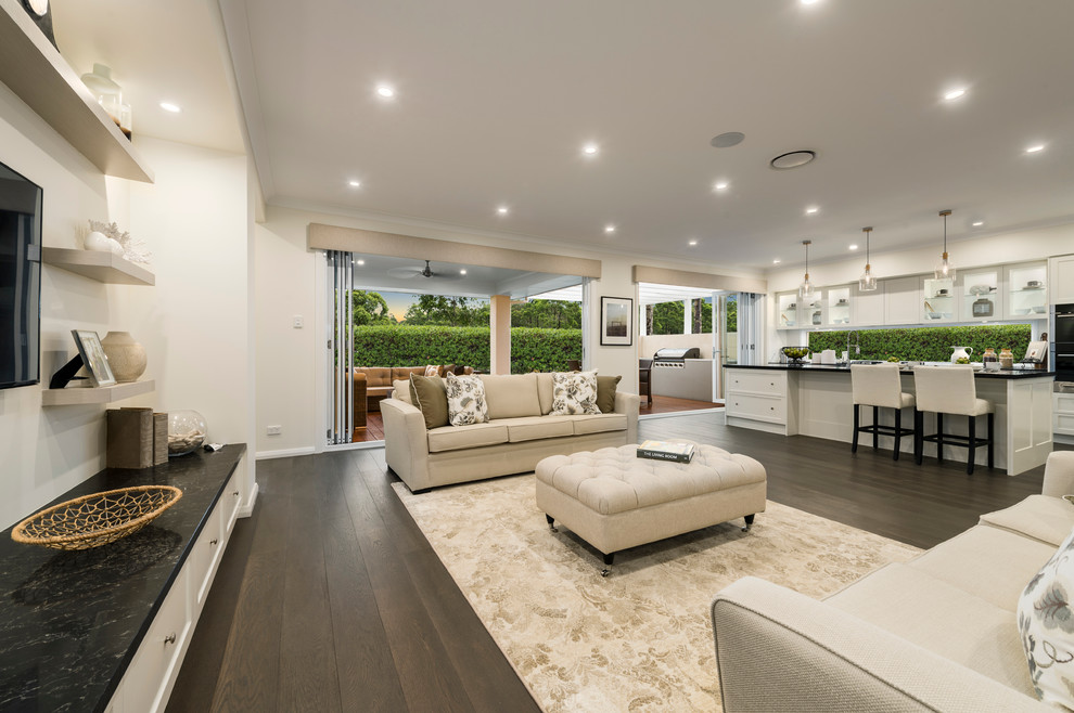 Expansive contemporary open concept family room in Sydney with beige walls, no fireplace and a wall-mounted tv.
