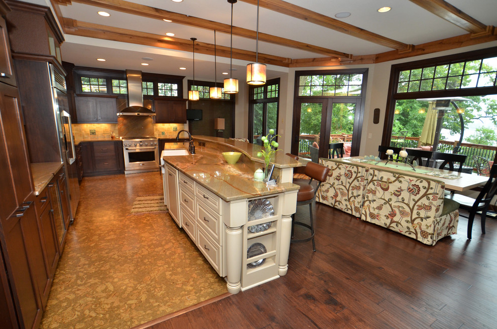 Eat-in kitchen - huge transitional cork floor eat-in kitchen idea in Milwaukee with a farmhouse sink, raised-panel cabinets, white cabinets, granite countertops, stone tile backsplash, stainless steel appliances and an island