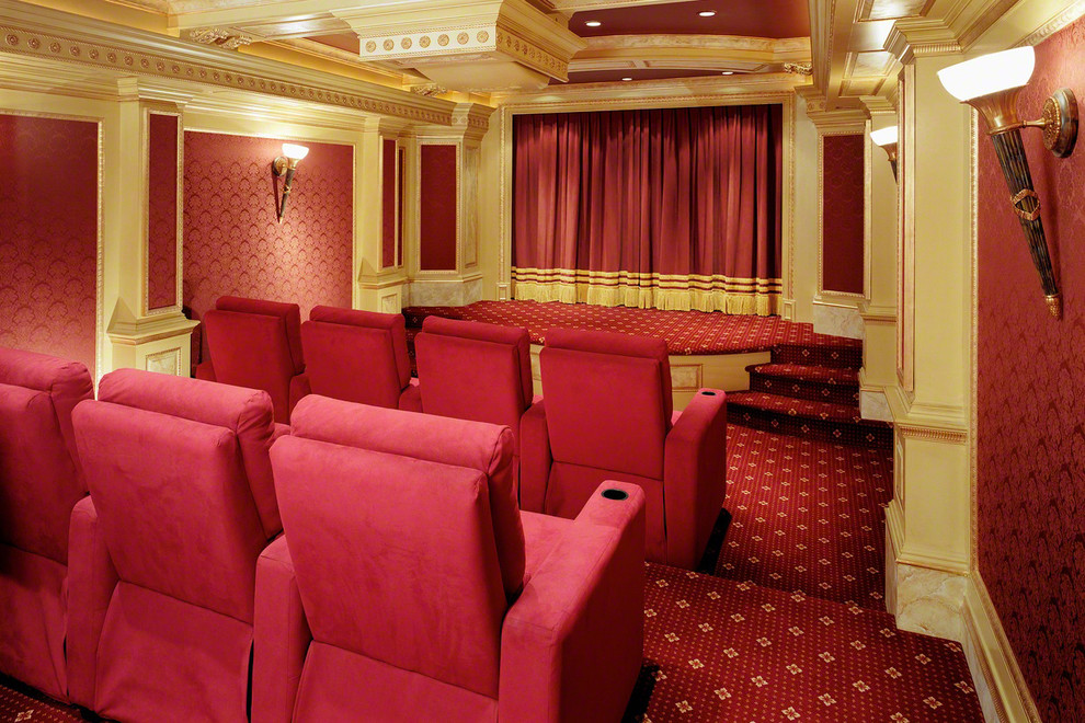 This is an example of a large traditional enclosed home theatre in New York with red walls, carpet, a projector screen and multi-coloured floor.