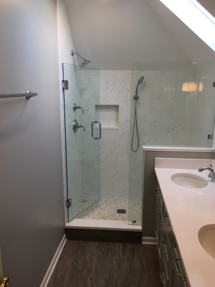 This is an example of a small contemporary master bathroom in Chicago with flat-panel cabinets, grey cabinets, an open shower, a two-piece toilet, gray tile, marble, grey walls, ceramic floors, an undermount sink, granite benchtops, brown floor, a hinged shower door and white benchtops.