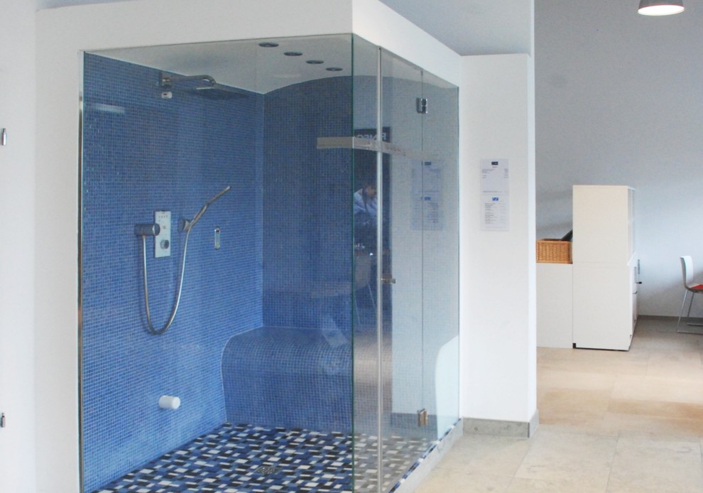 Photo of an expansive contemporary bathroom in Munich with an open shower, blue tile, mosaic tile, white walls and marble floors.