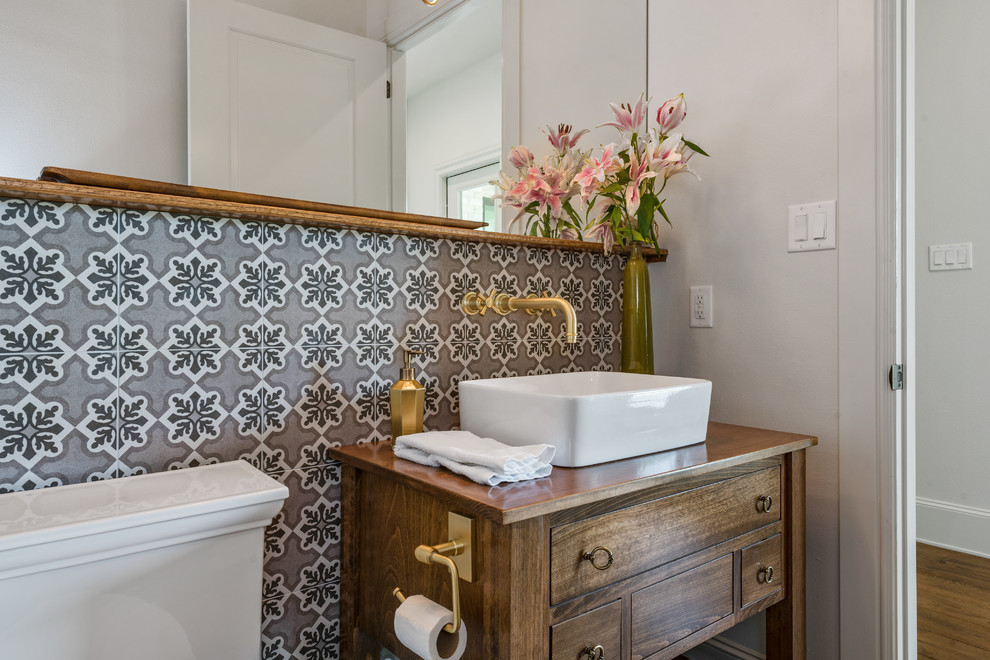 Traditional powder room in Austin with furniture-like cabinets, dark wood cabinets, white walls, dark hardwood floors, a vessel sink, wood benchtops, brown floor and brown benchtops.