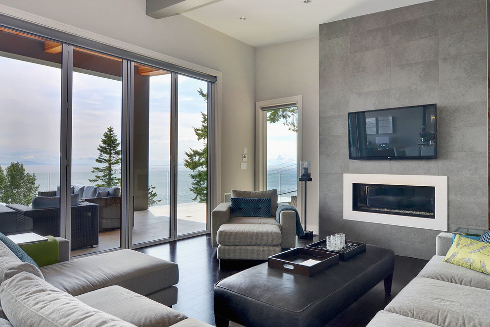 Large modern formal enclosed living room in Vancouver with grey walls, dark hardwood floors, a ribbon fireplace, a concrete fireplace surround, a wall-mounted tv and brown floor.