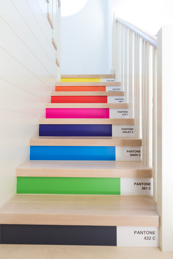 Design ideas for a contemporary wood straight staircase in Channel Islands with painted wood risers.