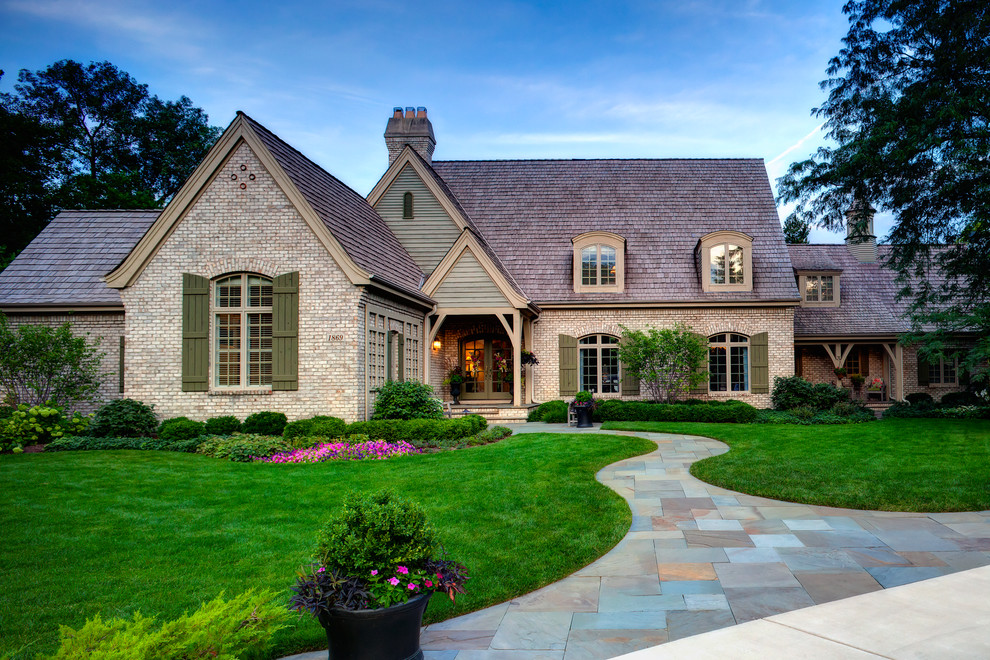 Design ideas for a large traditional front yard partial sun garden for summer in Chicago with natural stone pavers.