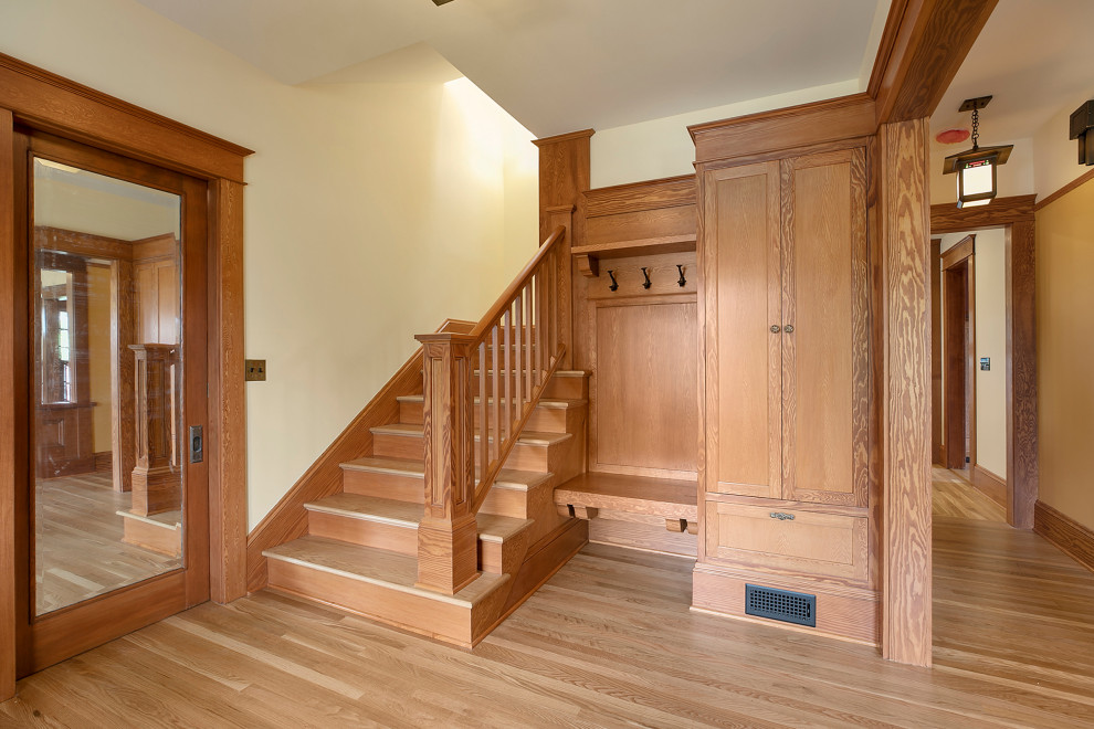 Design ideas for a large foyer in Portland with beige walls, medium hardwood flooring and a medium wood front door.