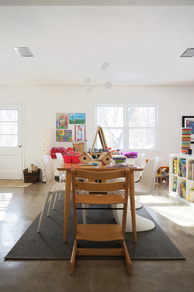Modern gender-neutral kids' playroom in Minneapolis with white walls and concrete floors for kids 4-10 years old.