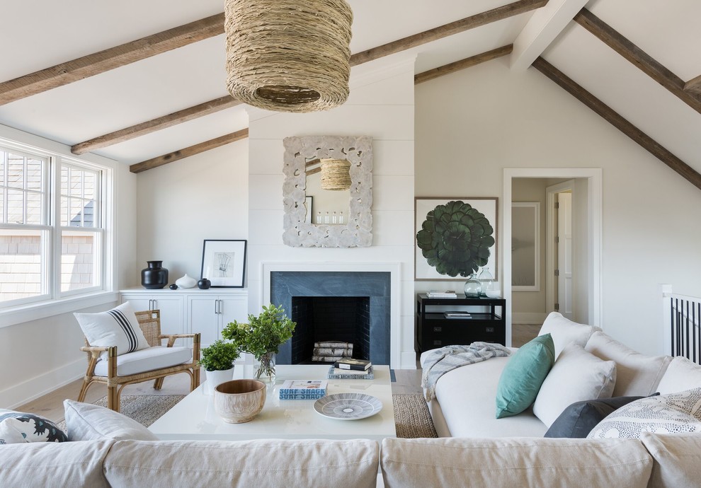 Inspiration for a mid-sized beach style formal loft-style living room in Providence with white walls, light hardwood floors, a standard fireplace, a metal fireplace surround, no tv and beige floor.