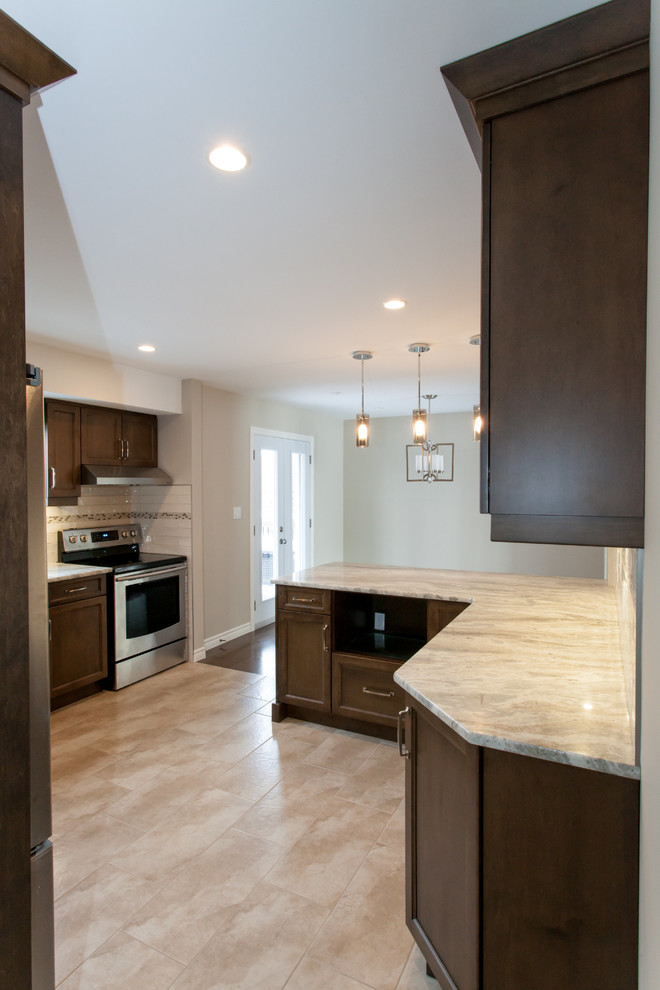 Eat-in kitchen - mid-sized transitional u-shaped porcelain tile eat-in kitchen idea in Toronto with an undermount sink, recessed-panel cabinets, dark wood cabinets, granite countertops, white backsplash, porcelain backsplash, stainless steel appliances and a peninsula