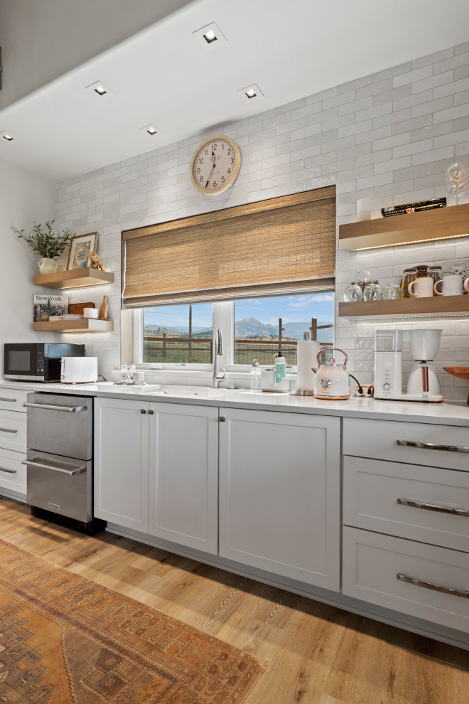 Inspiration for a small eclectic light wood floor and brown floor kitchen remodel with shaker cabinets and white cabinets
