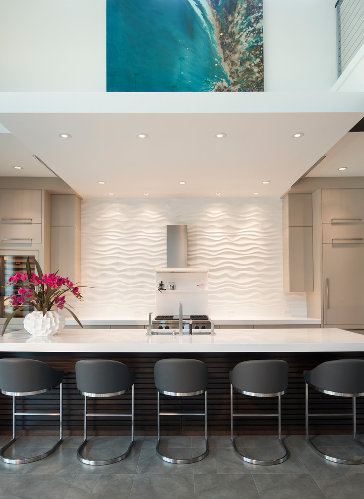 Inspiration for a large contemporary galley open plan kitchen in Miami with white splashback, with island, an undermount sink, flat-panel cabinets, beige cabinets, quartz benchtops, stainless steel appliances and porcelain floors.