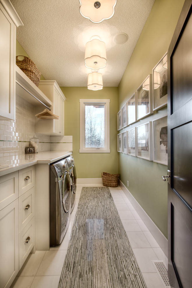 Inspiration for a large transitional single-wall dedicated laundry room in Calgary with a drop-in sink, shaker cabinets, white cabinets, laminate benchtops, green walls, marble floors and a side-by-side washer and dryer.