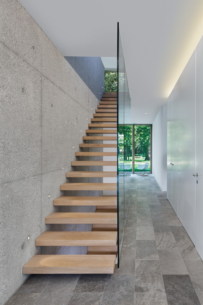 Inspiration for a mid-sized modern wood floating staircase in Munich with open risers.
