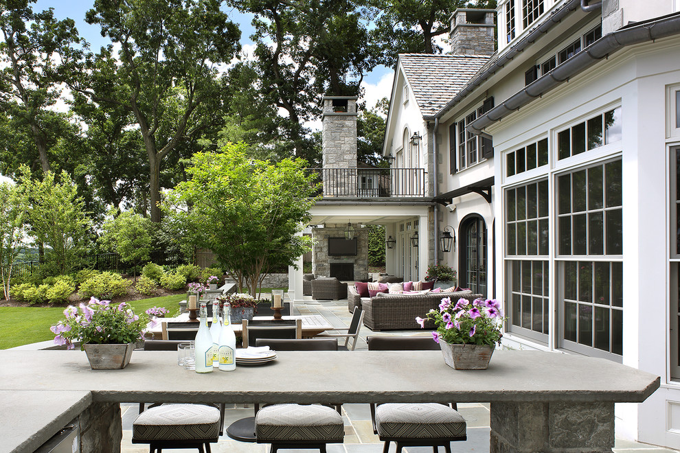 Design ideas for a large transitional backyard patio in New York with an outdoor kitchen and a roof extension.