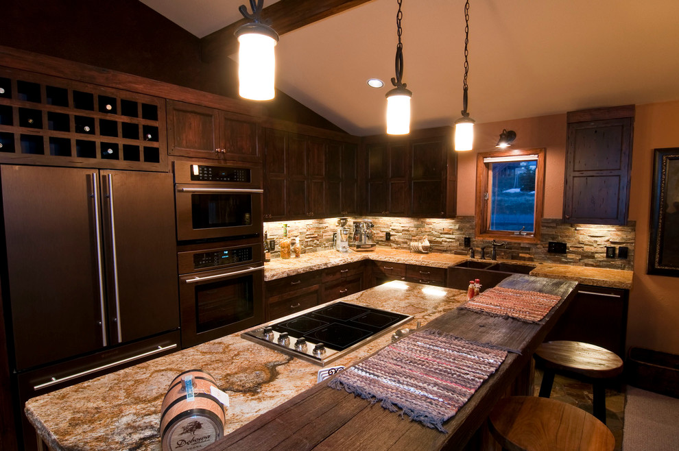 Large mountain style u-shaped slate floor eat-in kitchen photo with a farmhouse sink, raised-panel cabinets, medium tone wood cabinets, granite countertops, multicolored backsplash, colored appliances, orange walls and an island