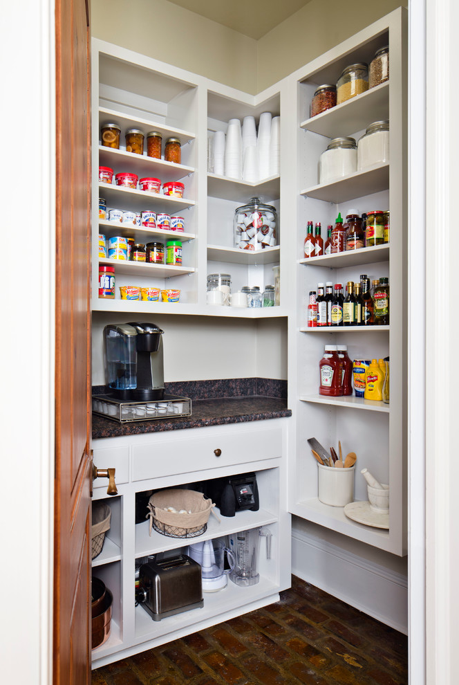 Photo of a traditional kitchen pantry in New Orleans with open cabinets, white cabinets, laminate benchtops and brick floors.