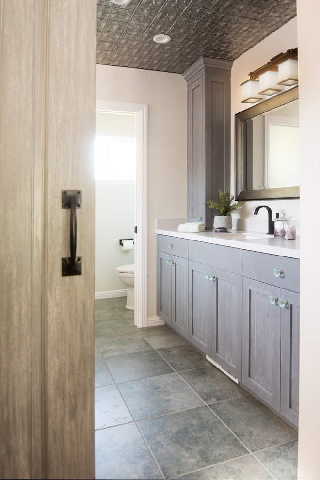Inspiration for a large transitional master wet room bathroom in San Francisco with shaker cabinets, blue cabinets, an undermount tub, a two-piece toilet, green tile, slate, white walls, porcelain floors, an undermount sink, engineered quartz benchtops, green floor and a hinged shower door.