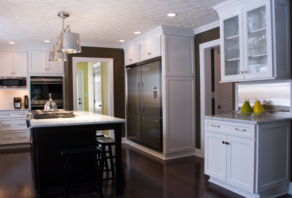 Kitchen - large transitional dark wood floor kitchen idea with an undermount sink, white cabinets, marble countertops, white backsplash, subway tile backsplash, stainless steel appliances and an island