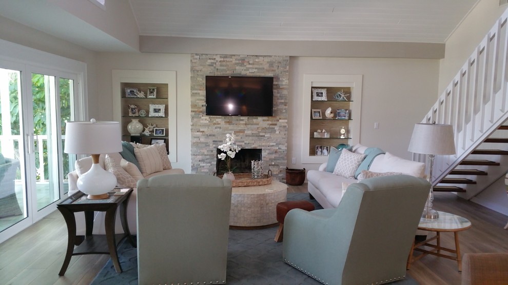 Mid-sized contemporary formal open concept living room in Tampa with beige walls, medium hardwood floors, a standard fireplace, a brick fireplace surround, a wall-mounted tv and brown floor.