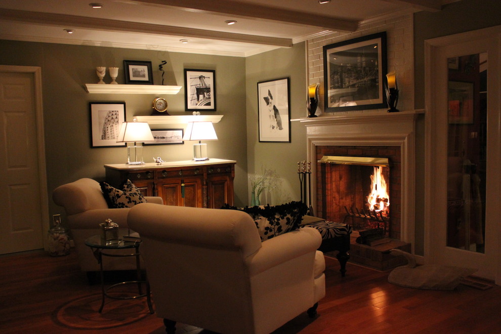 Small traditional formal enclosed living room in Other with green walls, dark hardwood floors, a standard fireplace, a brick fireplace surround and no tv.