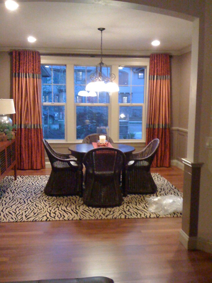 Example of a small minimalist dark wood floor and brown floor enclosed dining room design with brown walls