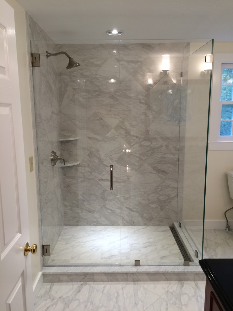 Inspiration for a large traditional master bathroom in Boston with raised-panel cabinets, dark wood cabinets, a two-piece toilet, white tile, porcelain tile, porcelain floors, an undermount sink and granite benchtops.
