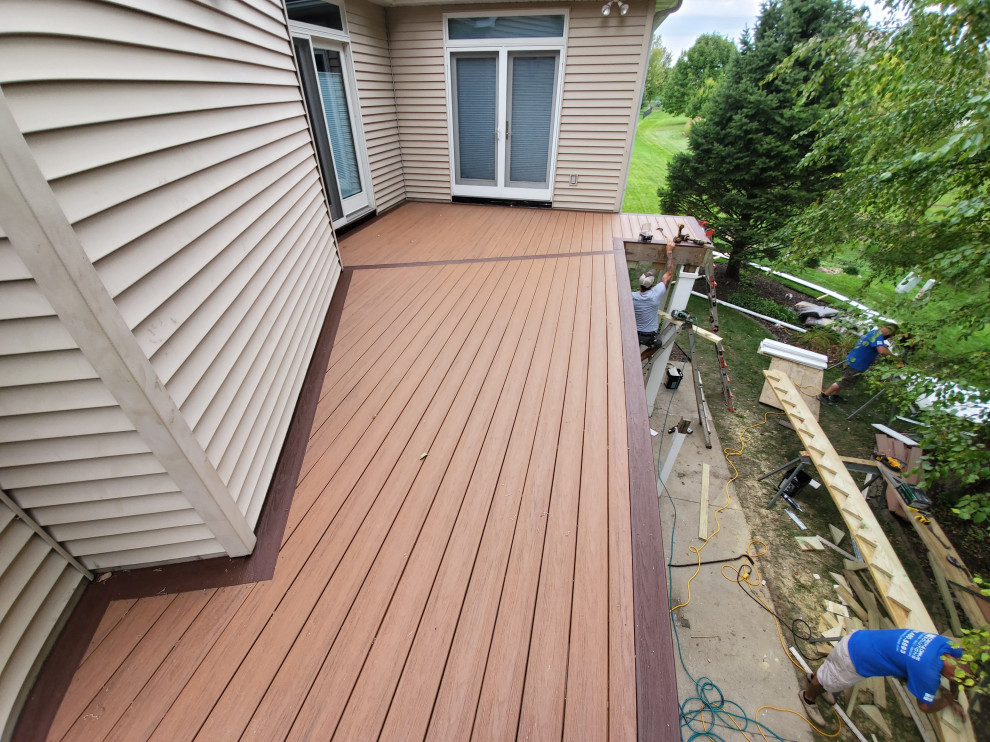 Mid-sized backyard second story metal railing deck photo with no cover