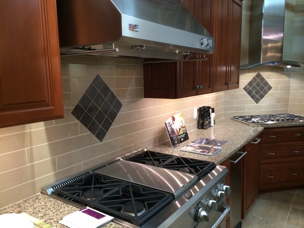 Example of a large transitional l-shaped porcelain tile eat-in kitchen design with recessed-panel cabinets, light wood cabinets, granite countertops, beige backsplash, porcelain backsplash, stainless steel appliances and a peninsula