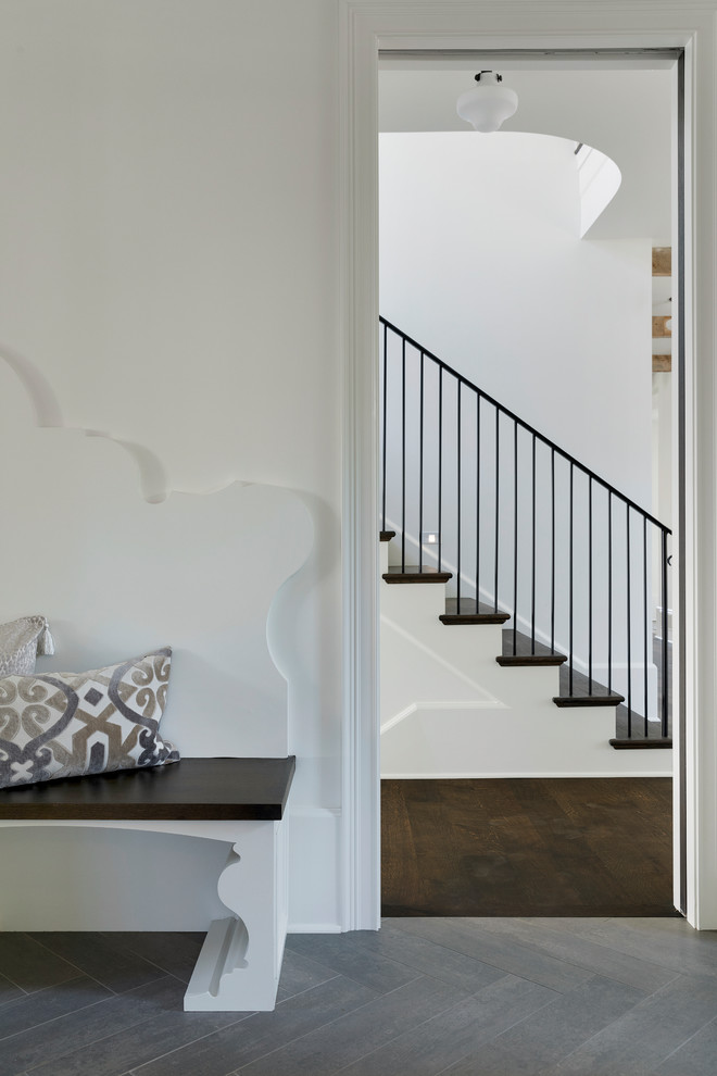 This is an example of a mid-sized traditional wood u-shaped staircase in Minneapolis with wood risers and metal railing.