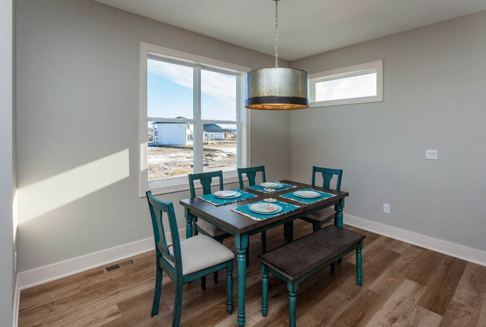 Example of a mid-sized transitional light wood floor and brown floor kitchen/dining room combo design with gray walls and no fireplace