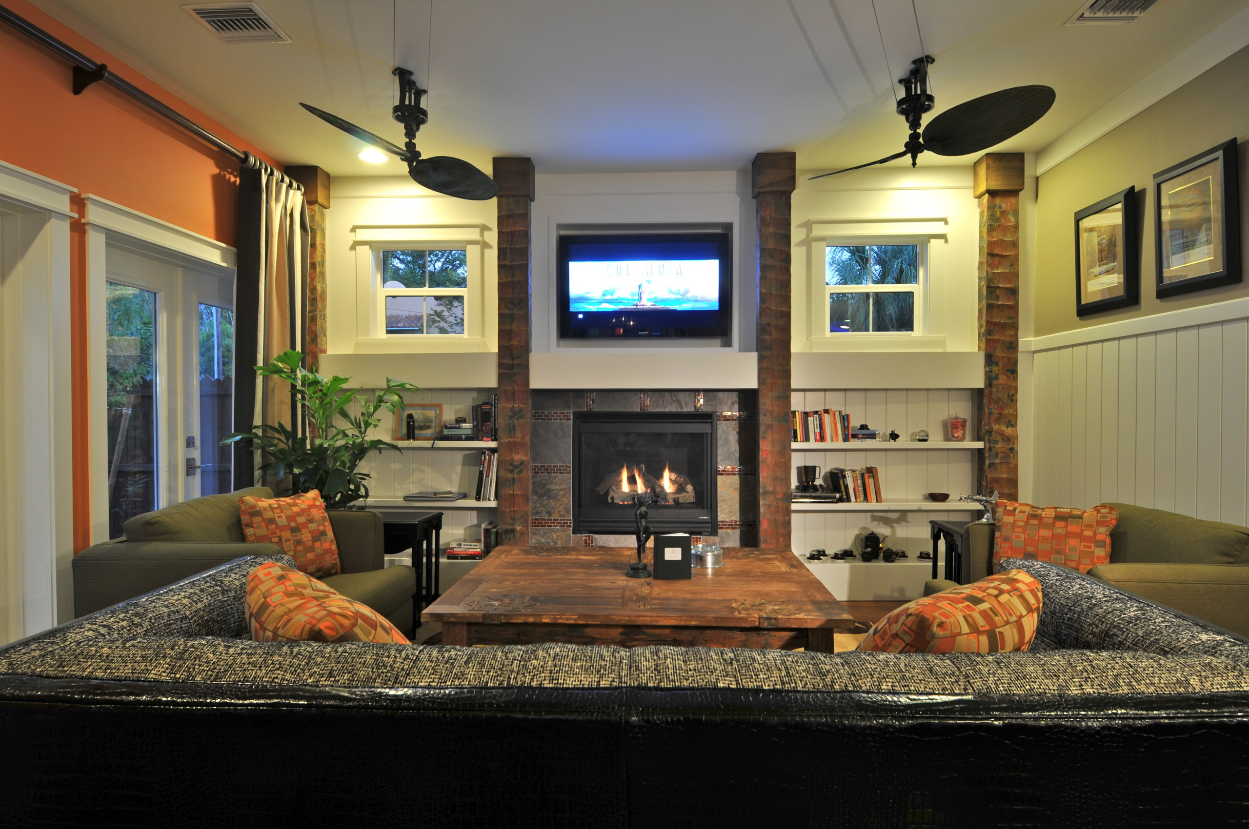 Fireplace columns made from reclaimed hand hewed cypress ceiling beams from the famed Ringling Towers. The vertical wainscot conceals the trap door for the whole house home automation system. Coffee t