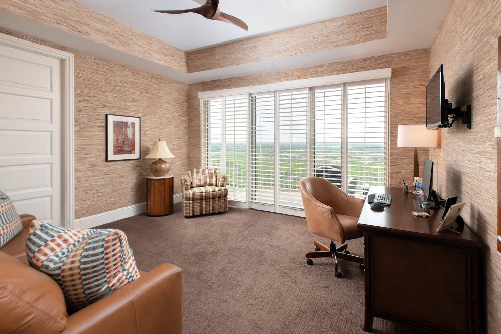 This is an example of a mid-sized contemporary home office in Miami with beige walls, carpet, a freestanding desk, brown floor, recessed and wallpaper.