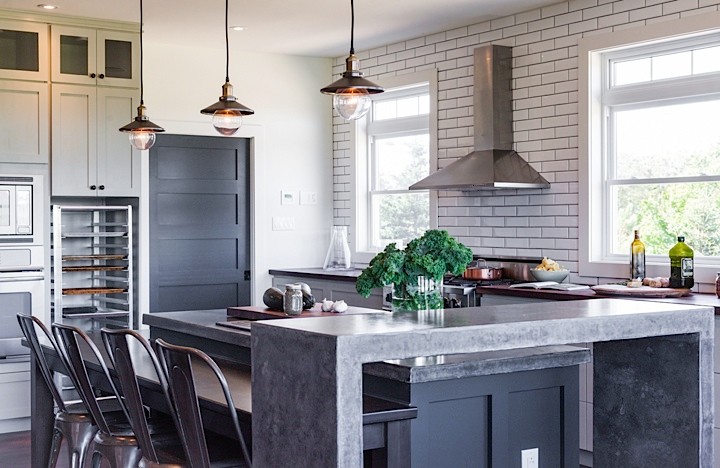 Large mountain style u-shaped medium tone wood floor eat-in kitchen photo with an integrated sink, shaker cabinets, green cabinets, concrete countertops, white backsplash, subway tile backsplash, stainless steel appliances and an island