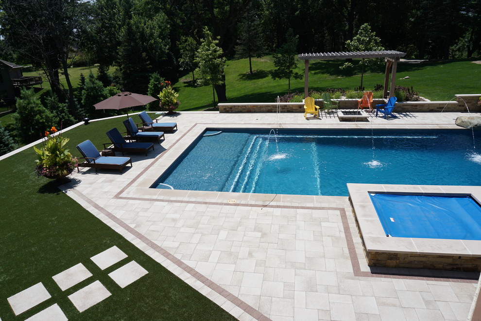 Inspiration for a large transitional backyard rectangular lap pool in Other with a water slide and concrete pavers.
