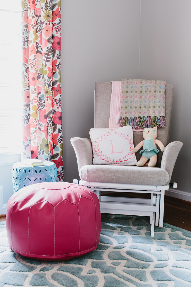 Design ideas for a mid-sized traditional nursery for girls in Atlanta with grey walls and medium hardwood floors.