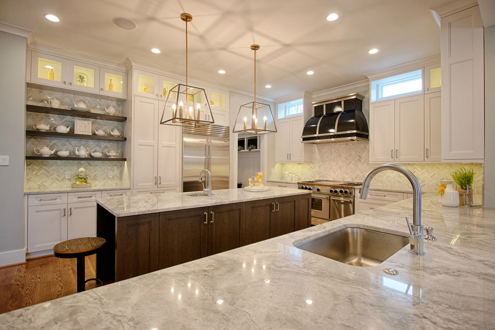 Photo of a large transitional u-shaped kitchen in DC Metro with recessed-panel cabinets, white cabinets, granite benchtops, white splashback, mosaic tile splashback, stainless steel appliances, medium hardwood floors and with island.
