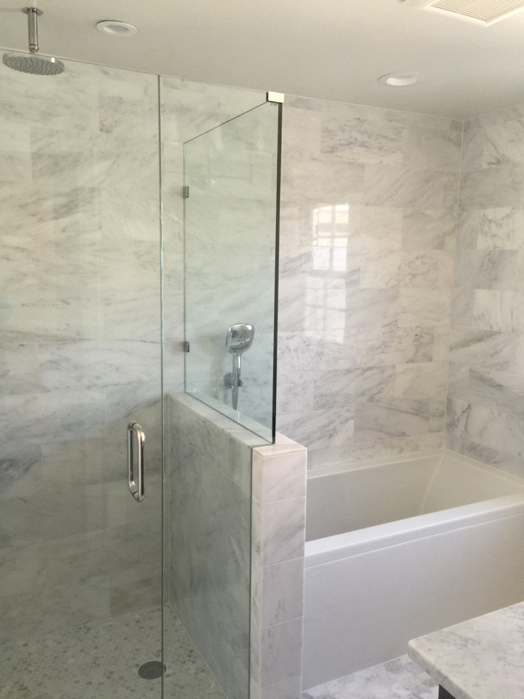 Inspiration for a small transitional bathroom in Detroit with an undermount sink, recessed-panel cabinets, white cabinets, marble benchtops, an alcove tub, an alcove shower, a two-piece toilet, multi-coloured tile, stone tile, white walls and marble floors.