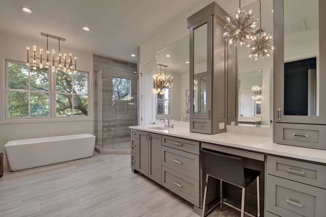 Example of a large transitional master gray tile and porcelain tile porcelain tile and gray floor freestanding bathtub design in Austin with shaker cabinets, gray cabinets, white walls, an undermount sink, quartzite countertops, a hinged shower door and white countertops