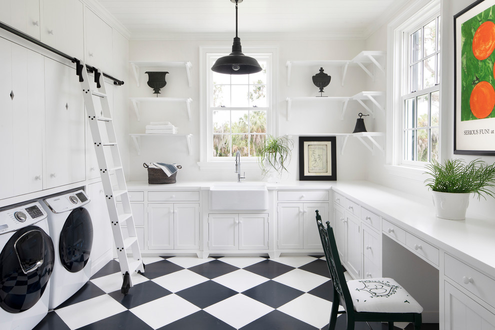 Design ideas for a large transitional u-shaped utility room in Tampa with a farmhouse sink, shaker cabinets, white cabinets, white walls, a side-by-side washer and dryer, white floor and white benchtop.
