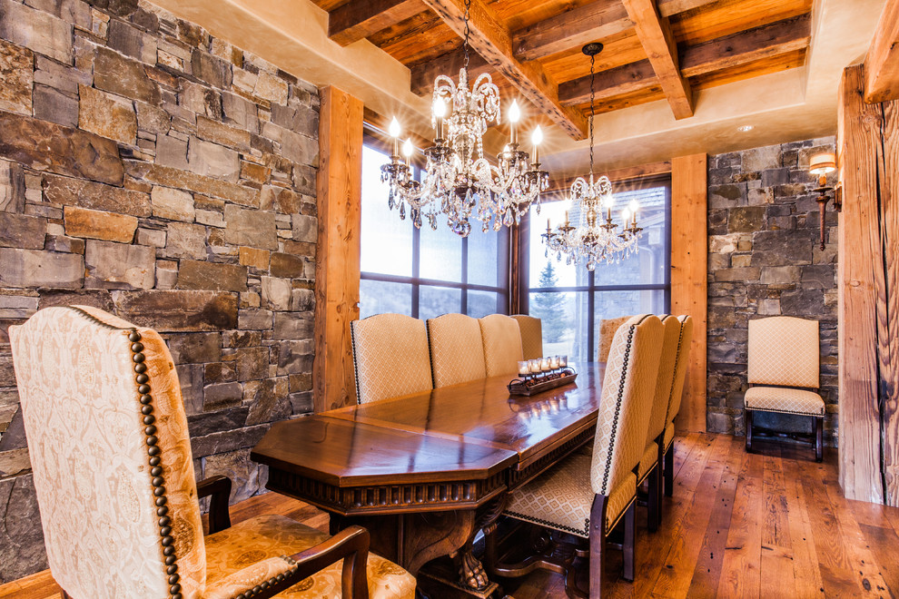 Mid-sized mountain style medium tone wood floor enclosed dining room photo with beige walls and no fireplace